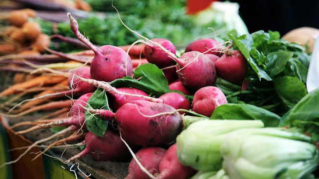multiple beets and radishes around other vegetables