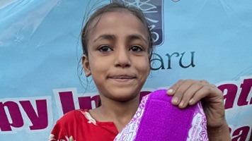 Girl holding up a Hanaru reusable sanitary napkin