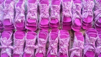 Fifteen packs of pink reusable sanitary napkins.