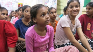 A group of girls listening to a talk on menstrual education