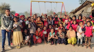 Pooja standing on the left of about fourty girls.