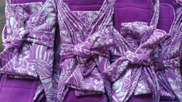 Four packs of fabric, purple and white, reusable sanitary napkins.