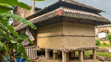 Traditional wooden and mud home with no windows.