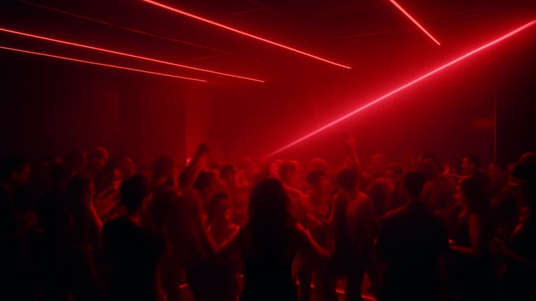 Sleek VIP lounge, ambient crimson lighting, stylish crowd gathered around a small dance floor