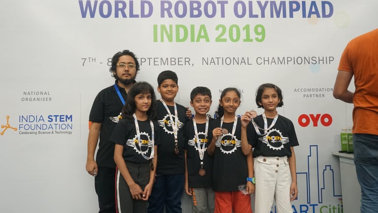 Students wearing medals at the World Robot Olympiad India 2019 National Championship for STEM.