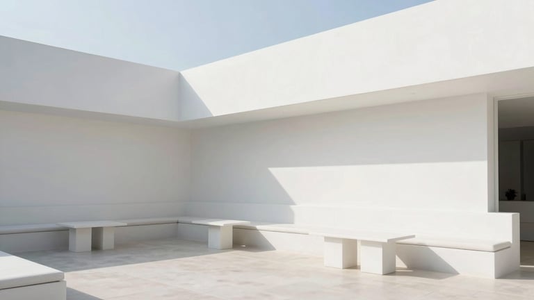 Wide architectural shot of the serene outdoor lounge, clean white walls, minimalist seating, soft shadows, bright natural daylight