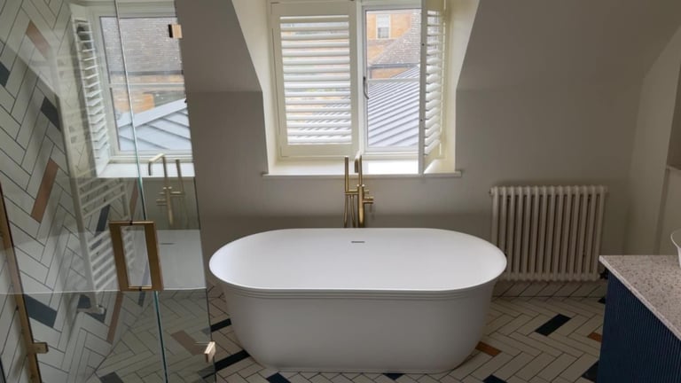a bathtub with a large tub in the middle of a bathroom in pershore 