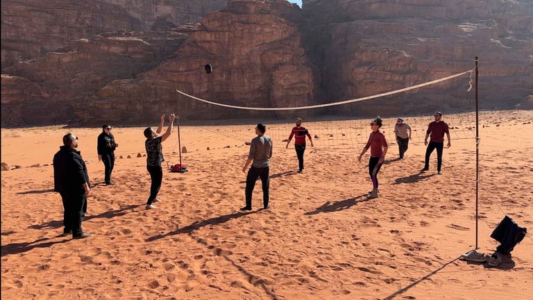 a group of people playing volleyball in the desert