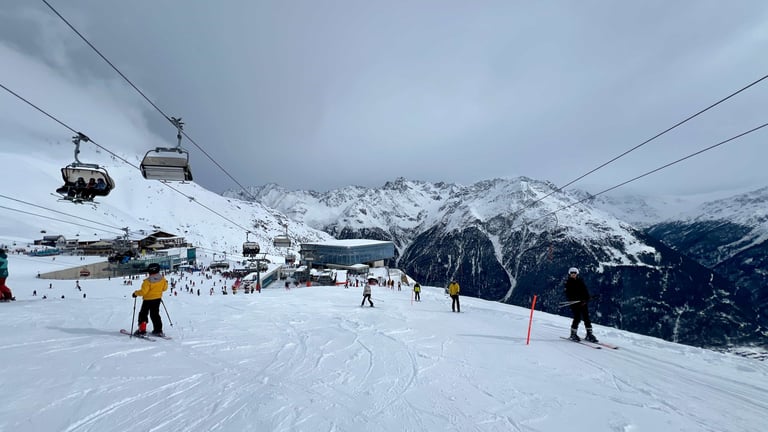 a ski lift in the mountains with people skiing