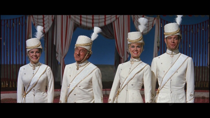 Circus set still from Jumbo (1962) with Doris Day, Jimmy Durante, and cast in white military‑style o