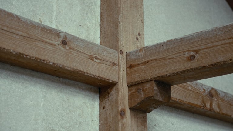 Macro detail shot of a traditional timber-frame mortise and tenon joint, natural overcast daylight, muted oak tones, 35mm film grain