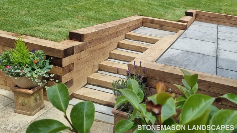 Sleeper Retaining Walls, Planters & Steps With Grey Sandstone Patio & Lawn
