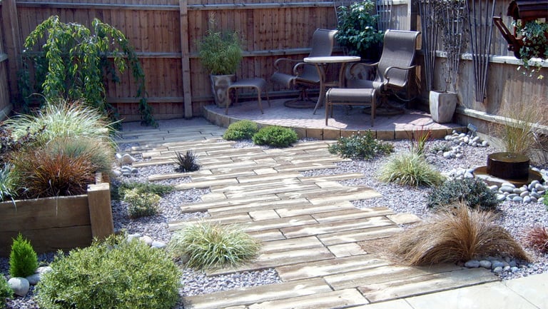Rustic driftwood beach effect small garden with water feature