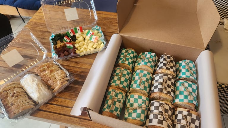 a box of cheese and a box of baguettes for catering