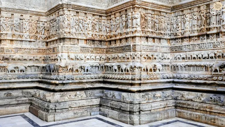 Intricate stone carvings at Jagdish Temple in Udaipur, showing detailed figures and mythological motifs.