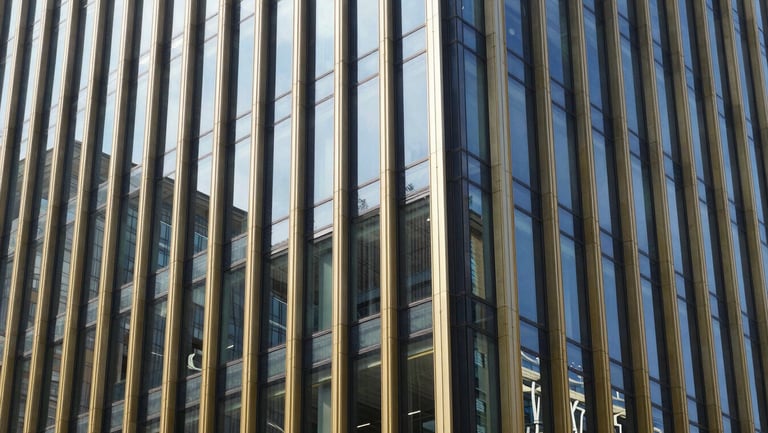 Modern corporate office building facade, geometric glass reflections, bright daylight, editorial style