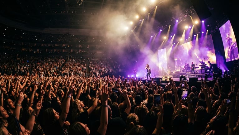 Low-angle wide shot of a packed concert arena, vibrant purple and gold spotlights cutting through haze, hands raised in the crowd, 35mm film grain