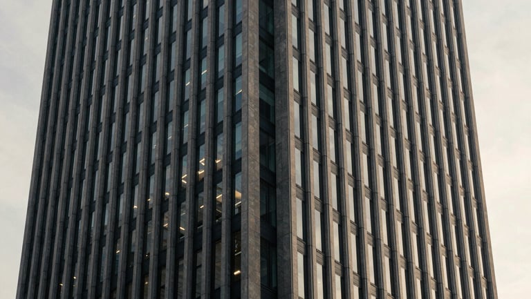 Architectural detail of a modern financial capital skyscraper in Zurich, soft morning window light, muted navy and warm gray tones, 35mm photography