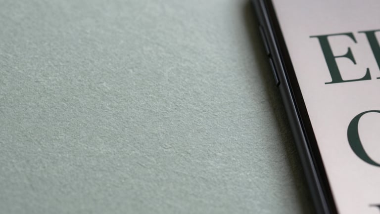 Macro shot of textured paper stocks and digital screen displaying matching typography, soft diffused daylight, muted slate and sage tones