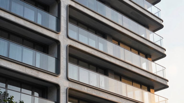 Architectural close-up of modern structural glass facade reflecting golden hour light, clean concrete lines, luxury development exterior.