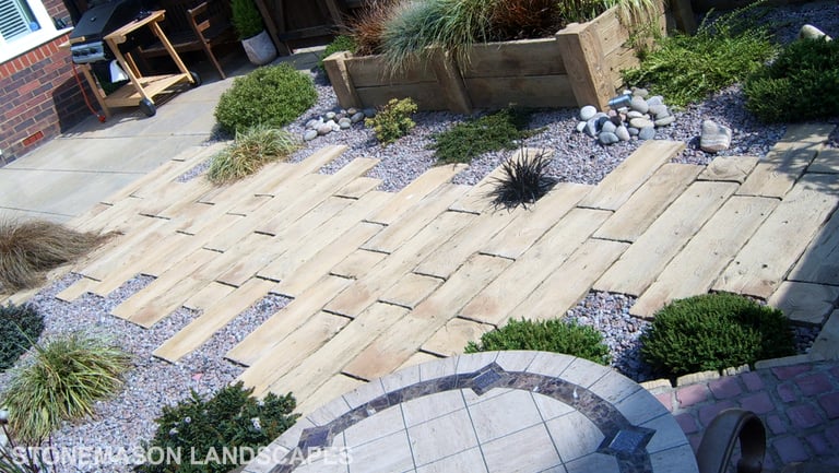 Rustic driftwood beach effect small garden with water feature