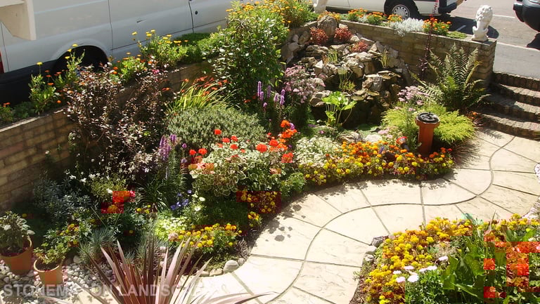 Curvey winding path, circle kits paving slabs weaving through lots of beautiful plants & flowers