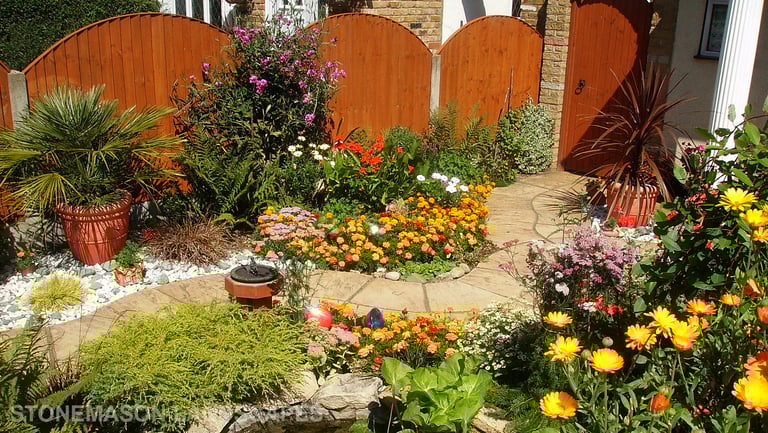 Curvey winding path, circle kits paving slabs weaving through lots of beautiful plants & flowers