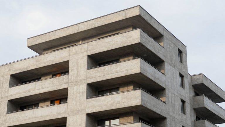 Modern concrete apartment block balcony detail, architectural geometry, overcast sky