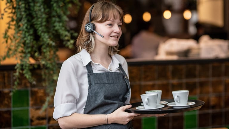 Restaurant waitress with headphones and PoC radio microphone.