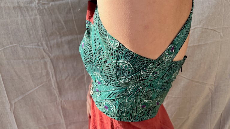 Side view of the bodice of a green and amber maxi dress