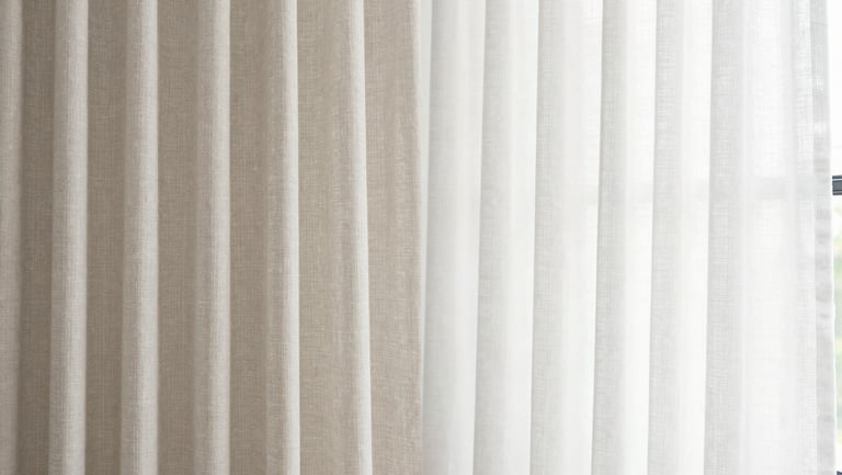 Before and after comparison of heavy linen curtains, left side dusty and grayed by pollution, right side bright white and crisp, natural window light, 35mm