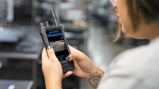 Warehouse manager reviewing CCTV footage on her PoC device