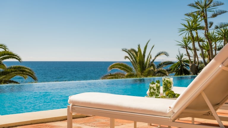 Pool area at Villa El Rincon in Marbella with ocean views, designer furnishings, and open-concept Mediterranean design