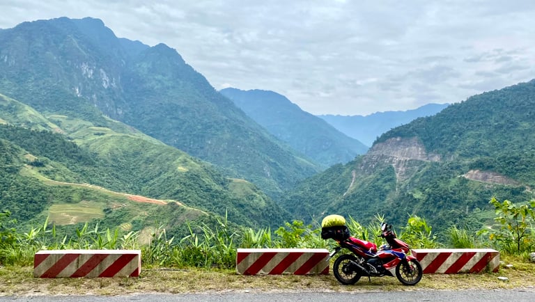 a motorcycle parked on a mountain side road