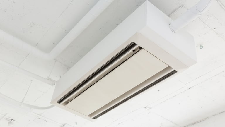 a ceiling mounted air conditioner with a white ceiling fan