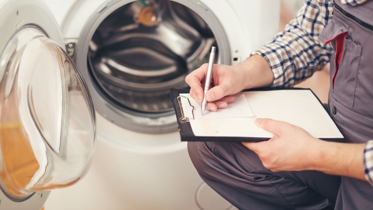 a man in overalls and overalls is writing on a clipboard