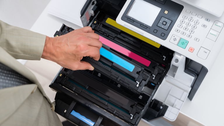 a man is holding a printer and a printer