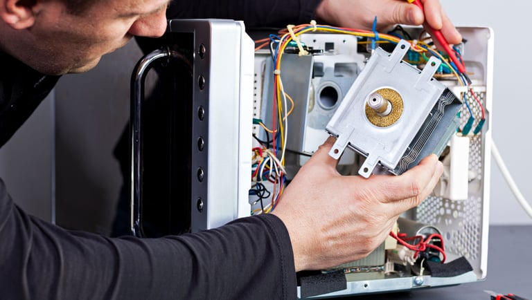 a man is fixing a computer monitor in a computer