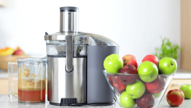 a blender with apples and apples in a bowl
