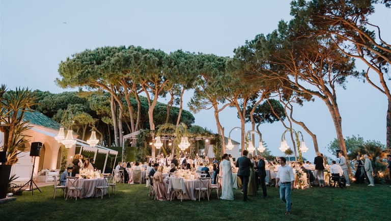 Evening wedding reception at Villa El Rincon with chandeliers and garden dining
