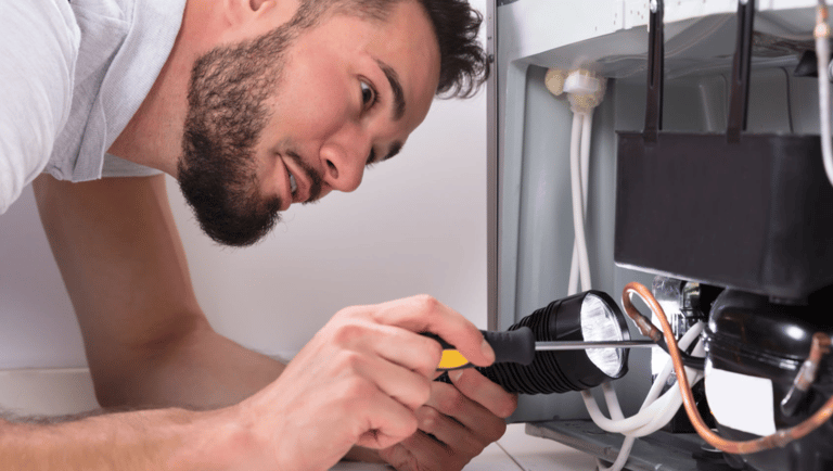 a man in a white shirt is looking at a computer screen