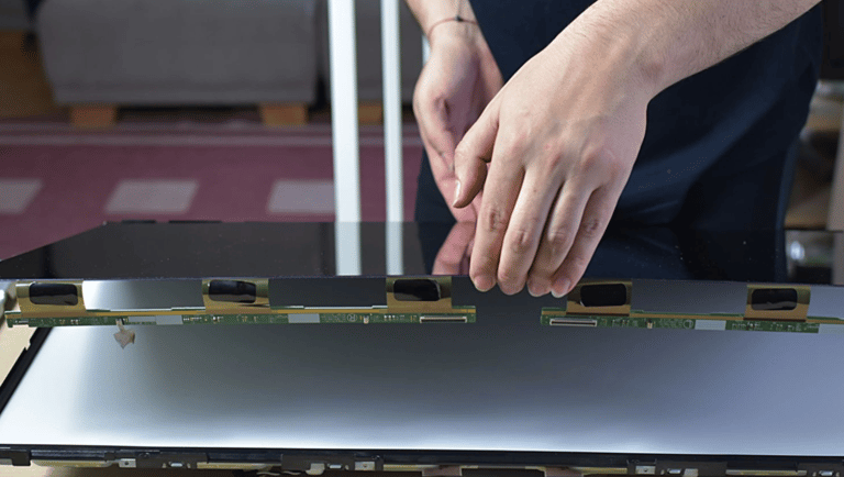 a person holding a laptop computer screen with a laptop on it
