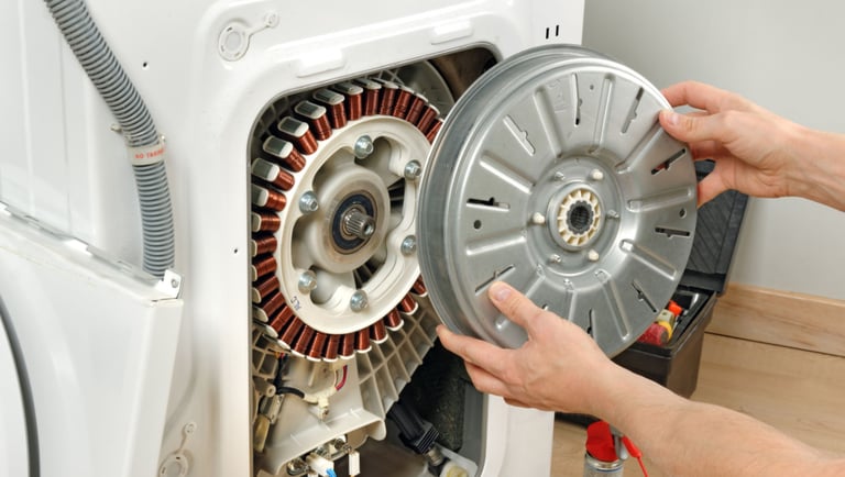 a person is fixing a motor cycle in a washing machine