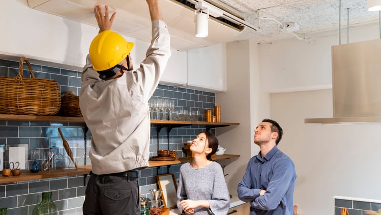 a man and woman standing in a kitchen