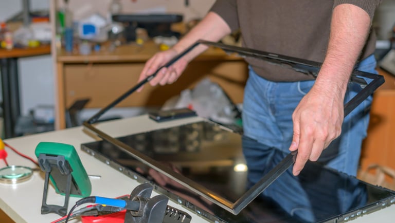 a man is holding a tablet computer and a tablet