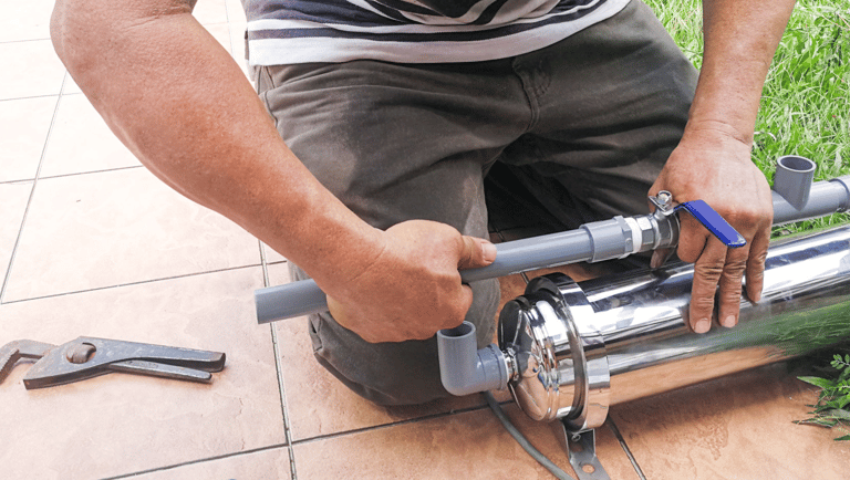 a man is using a pipe cutter to cut a pipe
