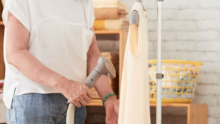 a woman in a white shirt is holding a vacuum