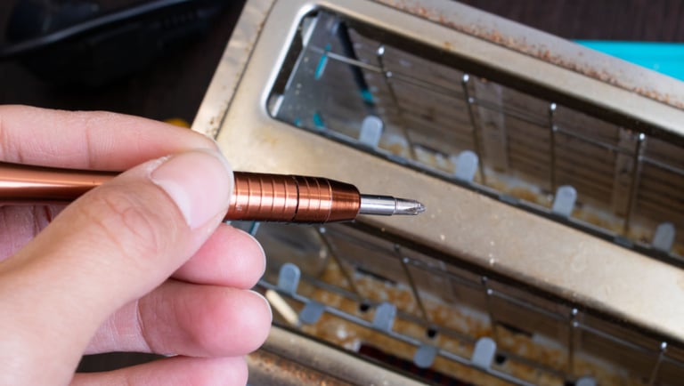 a person holding a pen and writing on a piece of paper