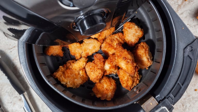 a fryer with chicken nuggling in it