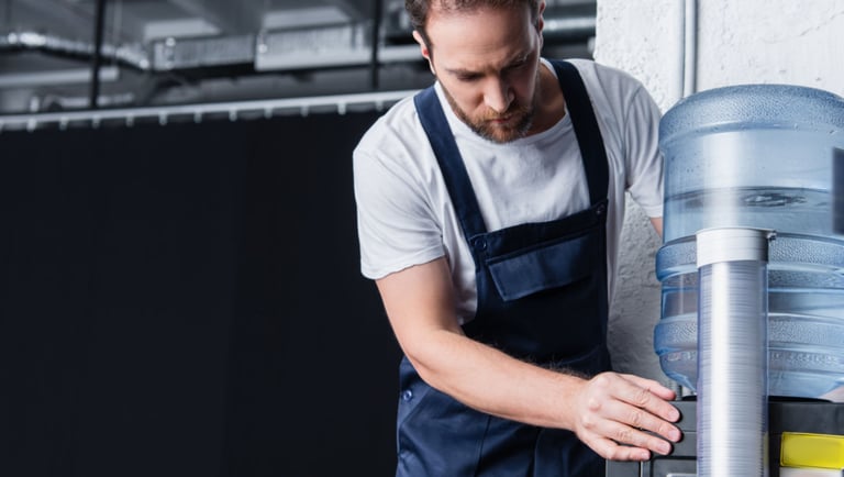 a man in overalls and overalls, a water bottle and a water di